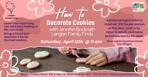 Photo of the arms of a person putting icing on sugar cookies.